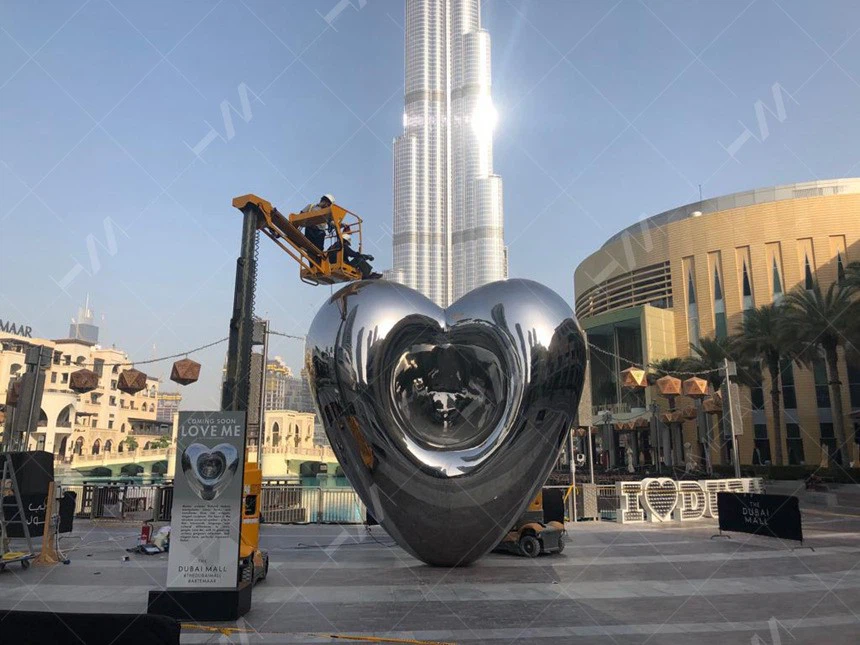 Installation of stainless steel Love Me sculpture